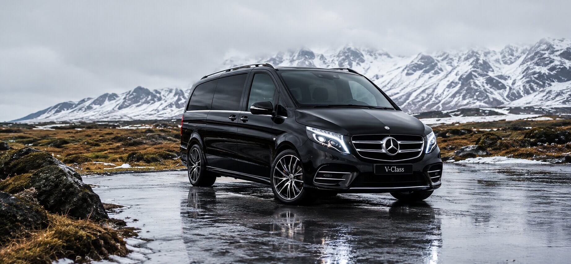 Black Mercedes V-Class in snowy mountains